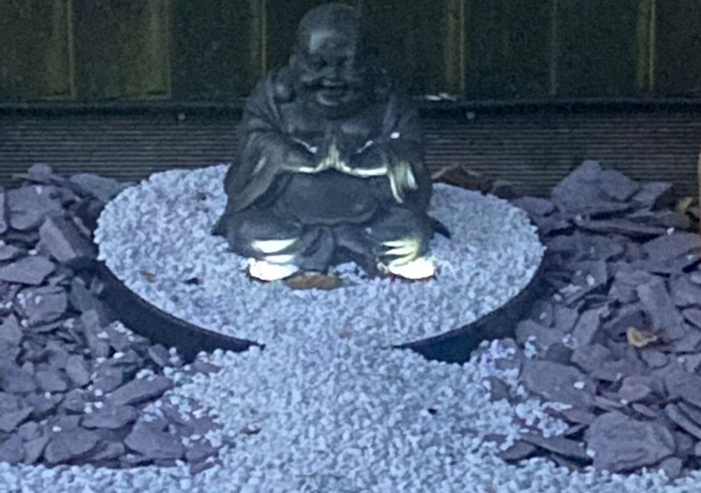Statue on a white gravel circle surrounded by slate in Bramhope
