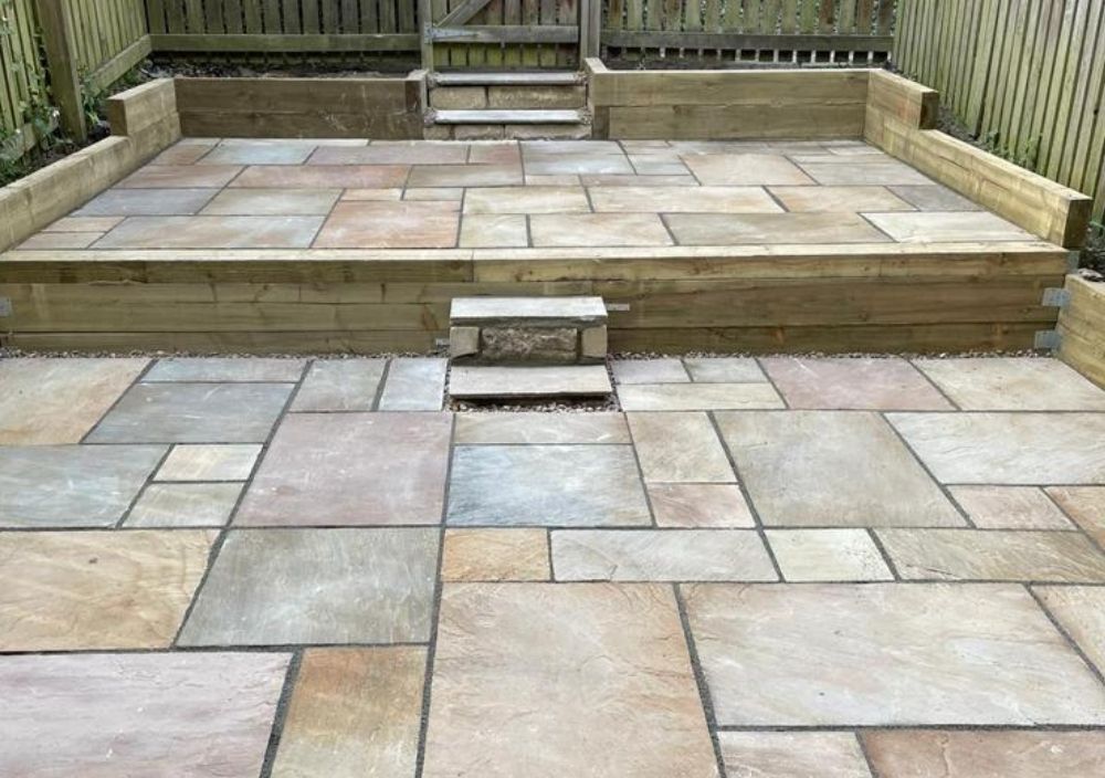 Raised natural stone patio with steps in Harehills, Leeds