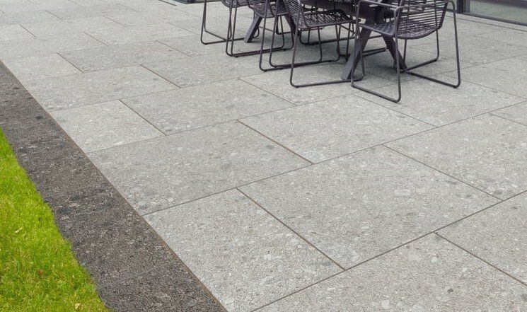 Light grey porcelain paving with a dark grey border
