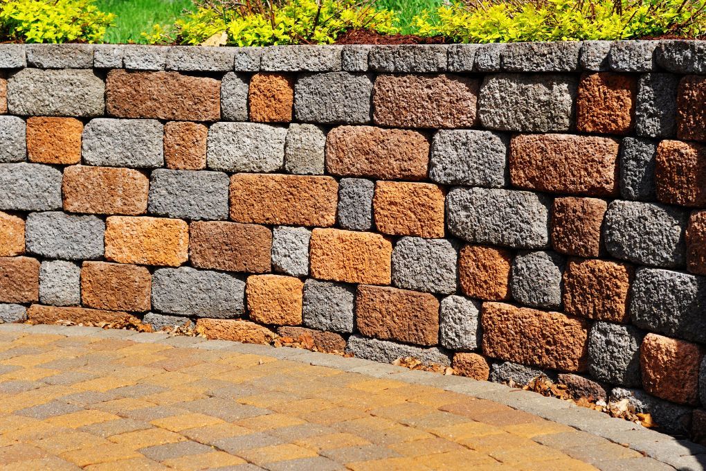Sandstone patio with retaining wall and steps to lawn area
