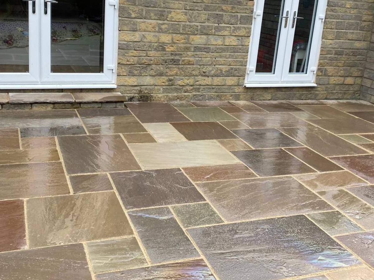 Close view of wet Raj green Indian sandstone paving in Whinmoor