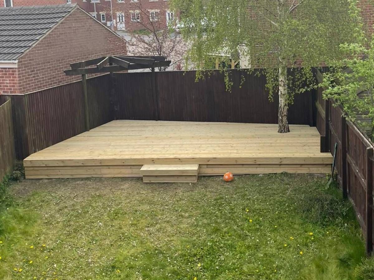 Finished timber deck with a step in a fenced Leeds garden