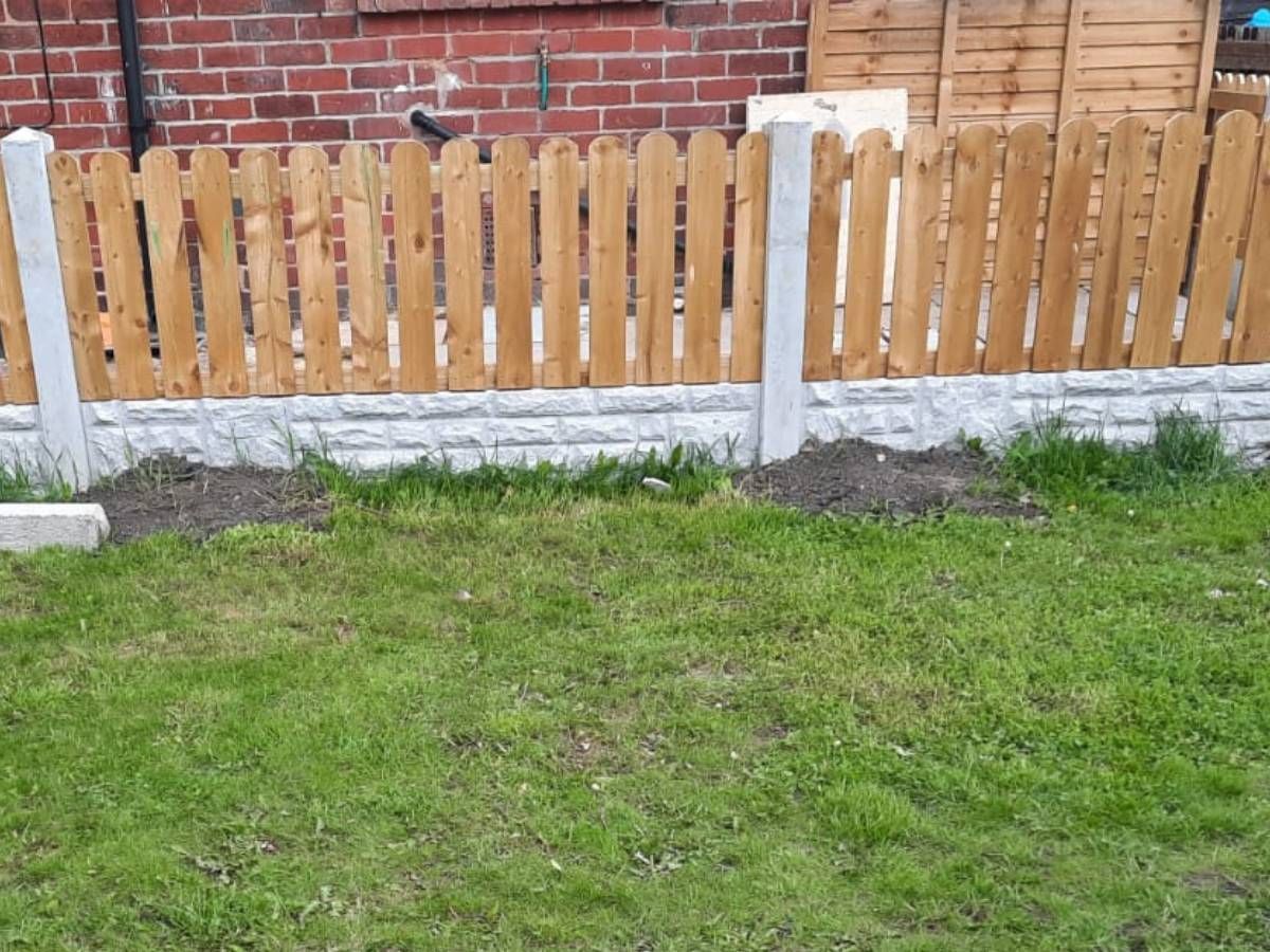 Short picket fence on concrete gravel boards in a Leeds garden