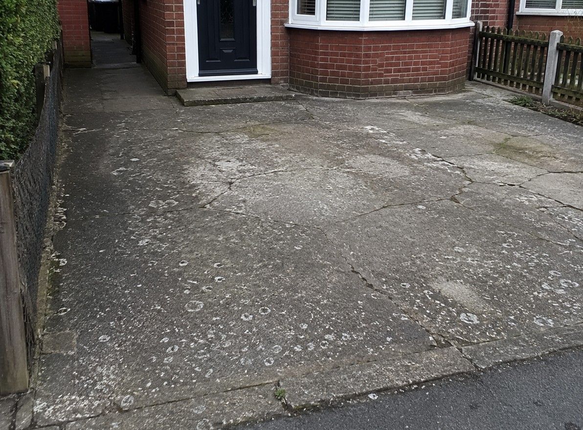 Cracked concrete driveway before gravel resurfacing in Leeds