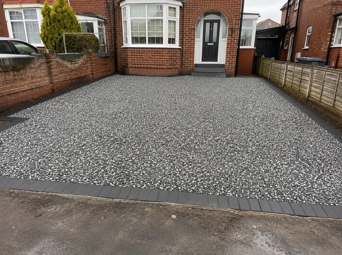 Newly installed grey gravel driveway with block paving edging in Leeds