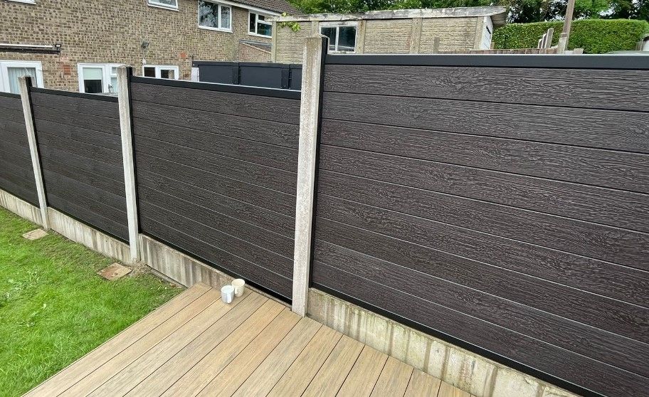 Chocolate brown composite panels fitted into existing concrete posts
