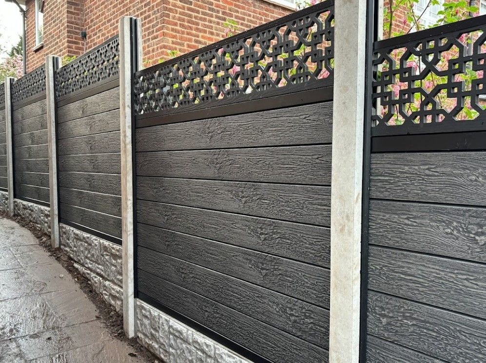 Stepped composite fence with concrete posts and rock-faced gravel boards