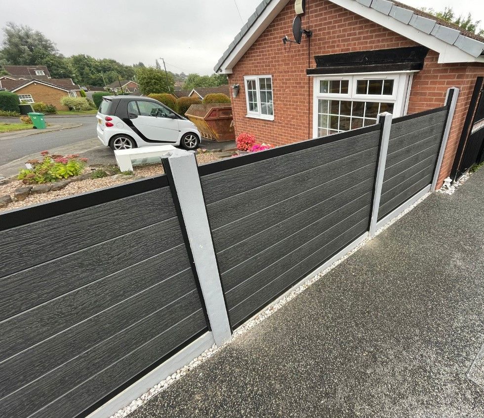 Graphite grey composite fencing with new concrete posts and smooth gravel boards