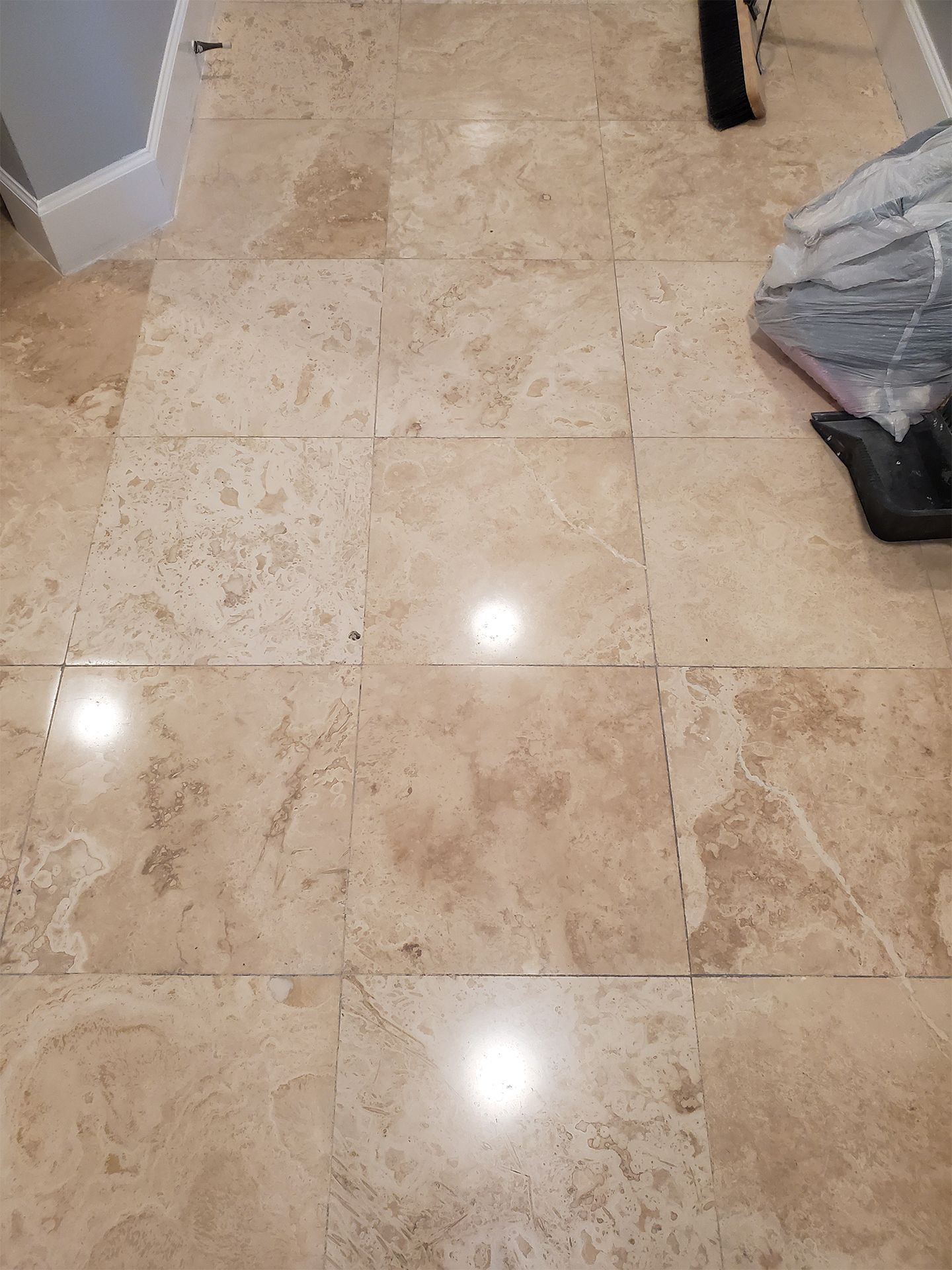 Natural stone travertine flooring in bathroom and hallway