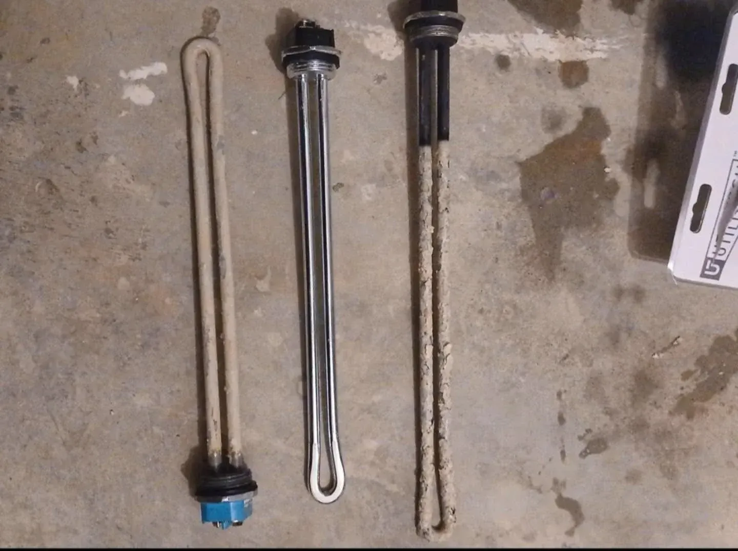 Water heater heating elements caked in hard water scale next to a clean element in Martinsburg, WV Water heater heating elements caked in hard water scale next to a clean element in Martinsburg, WV