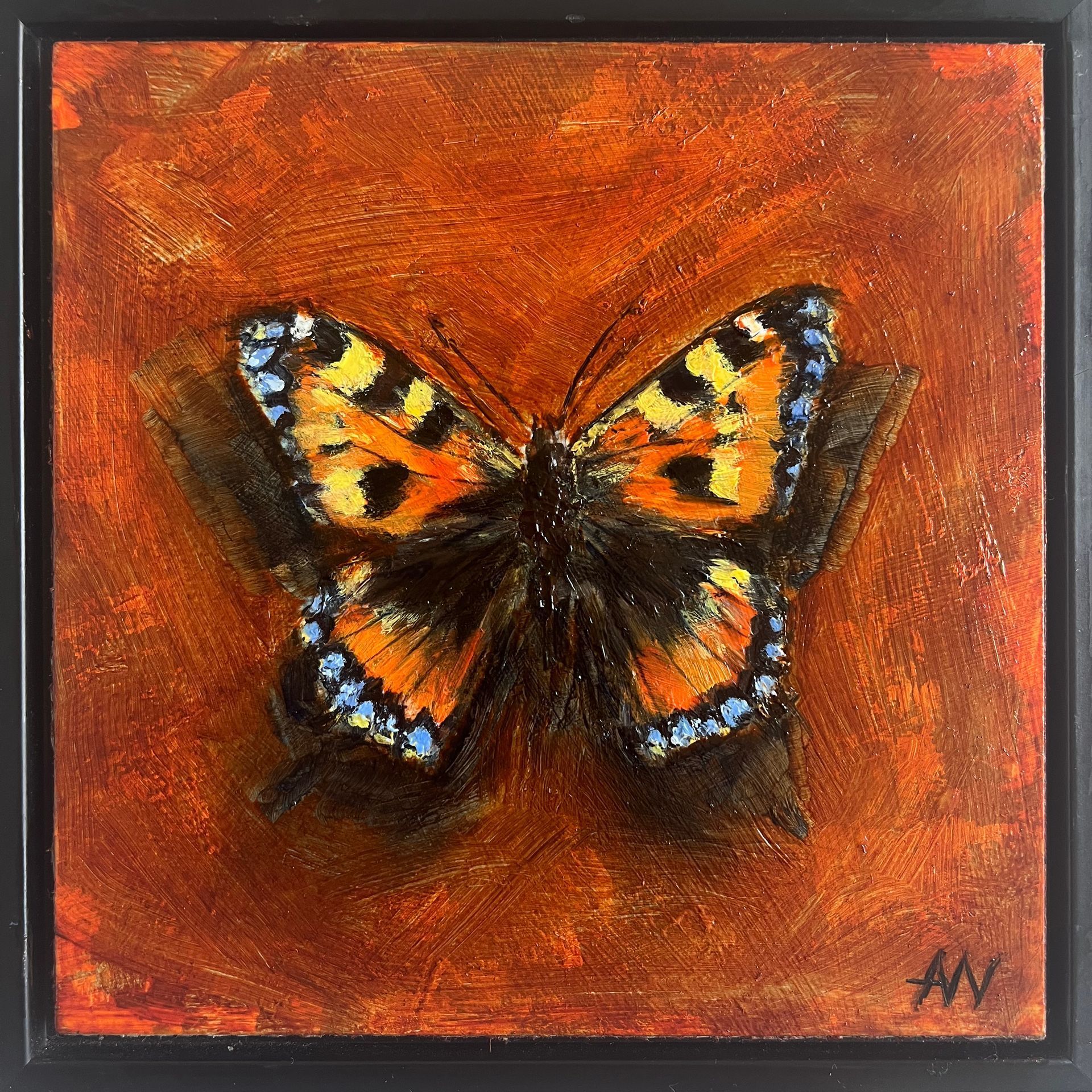 Orange and black butterfly on a reddish-orange background.