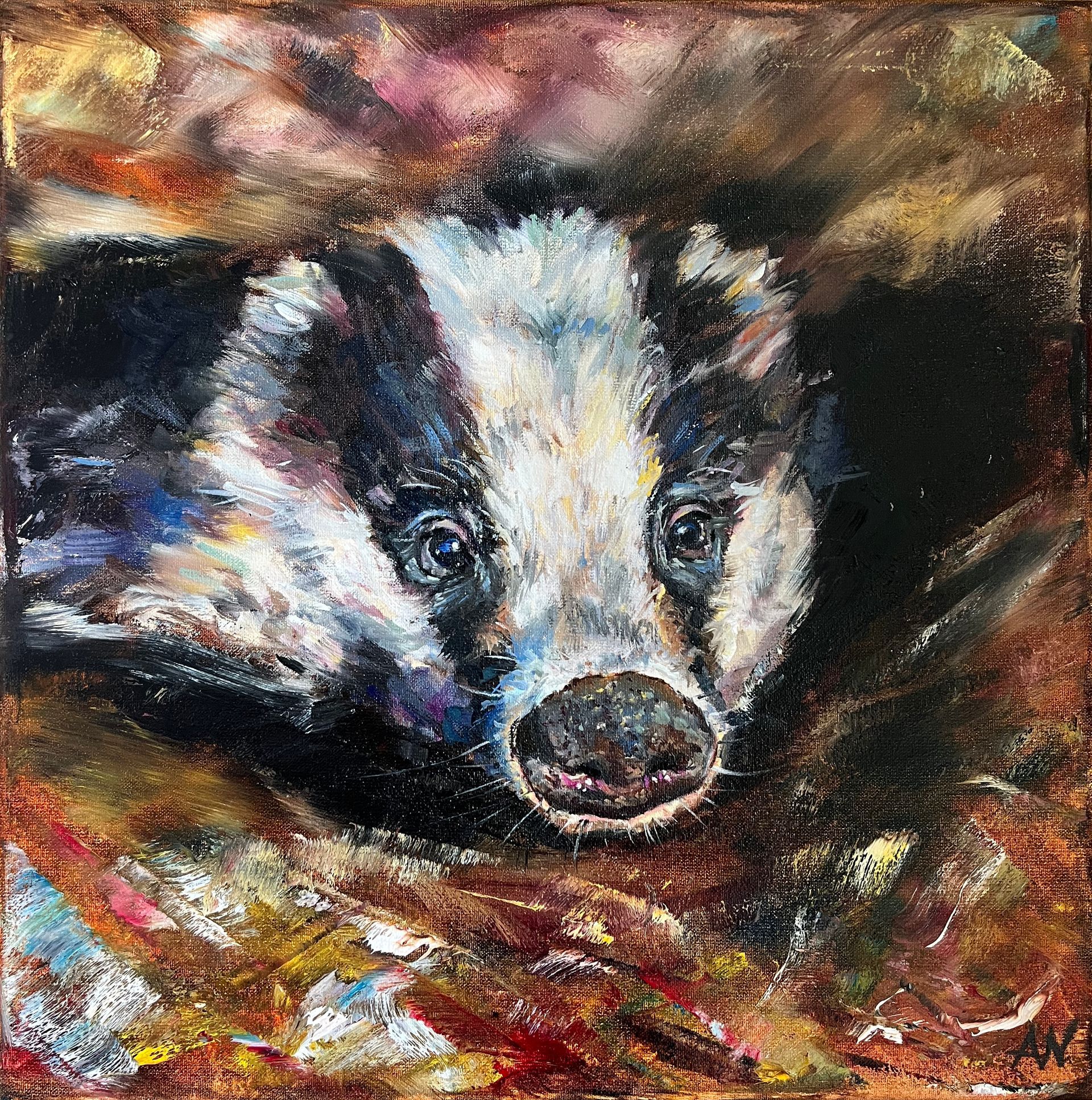 Badger with black and white fur peeking from earthy-colored foliage.
