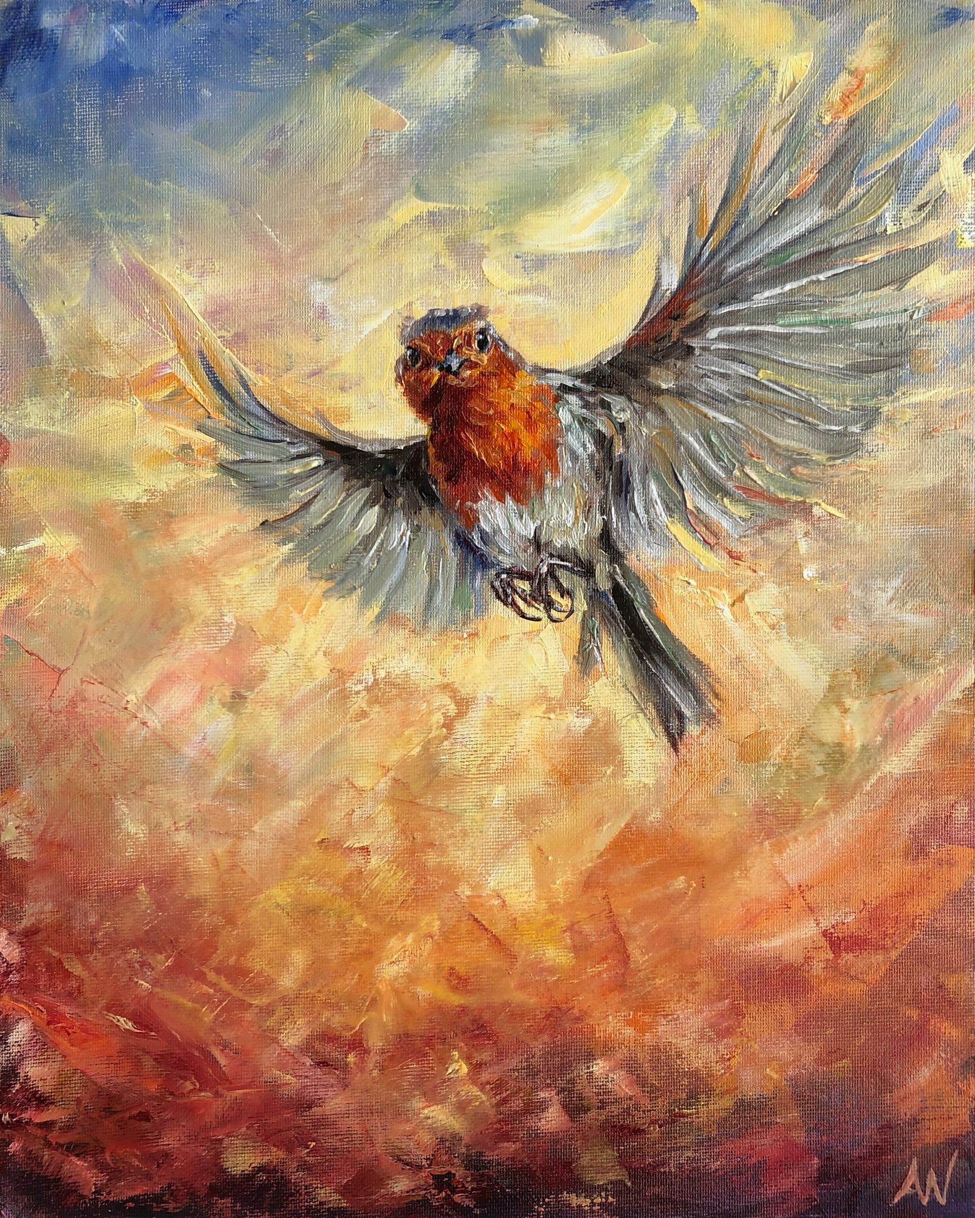 Robin in mid-flight against a blurred background of orange, red, and blue colors.