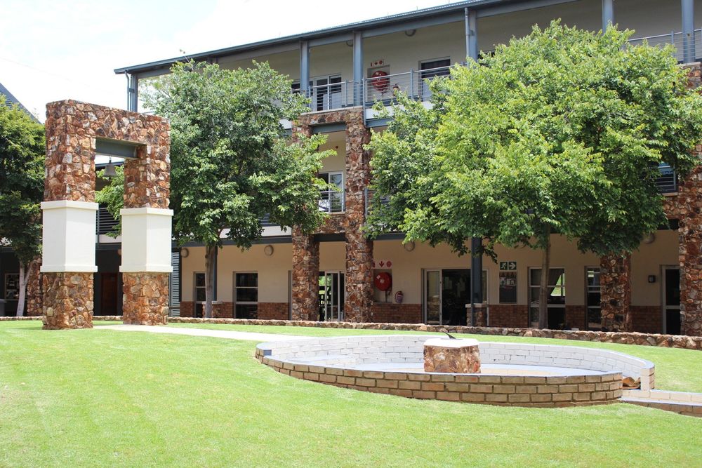 A large building with a fountain in front of it