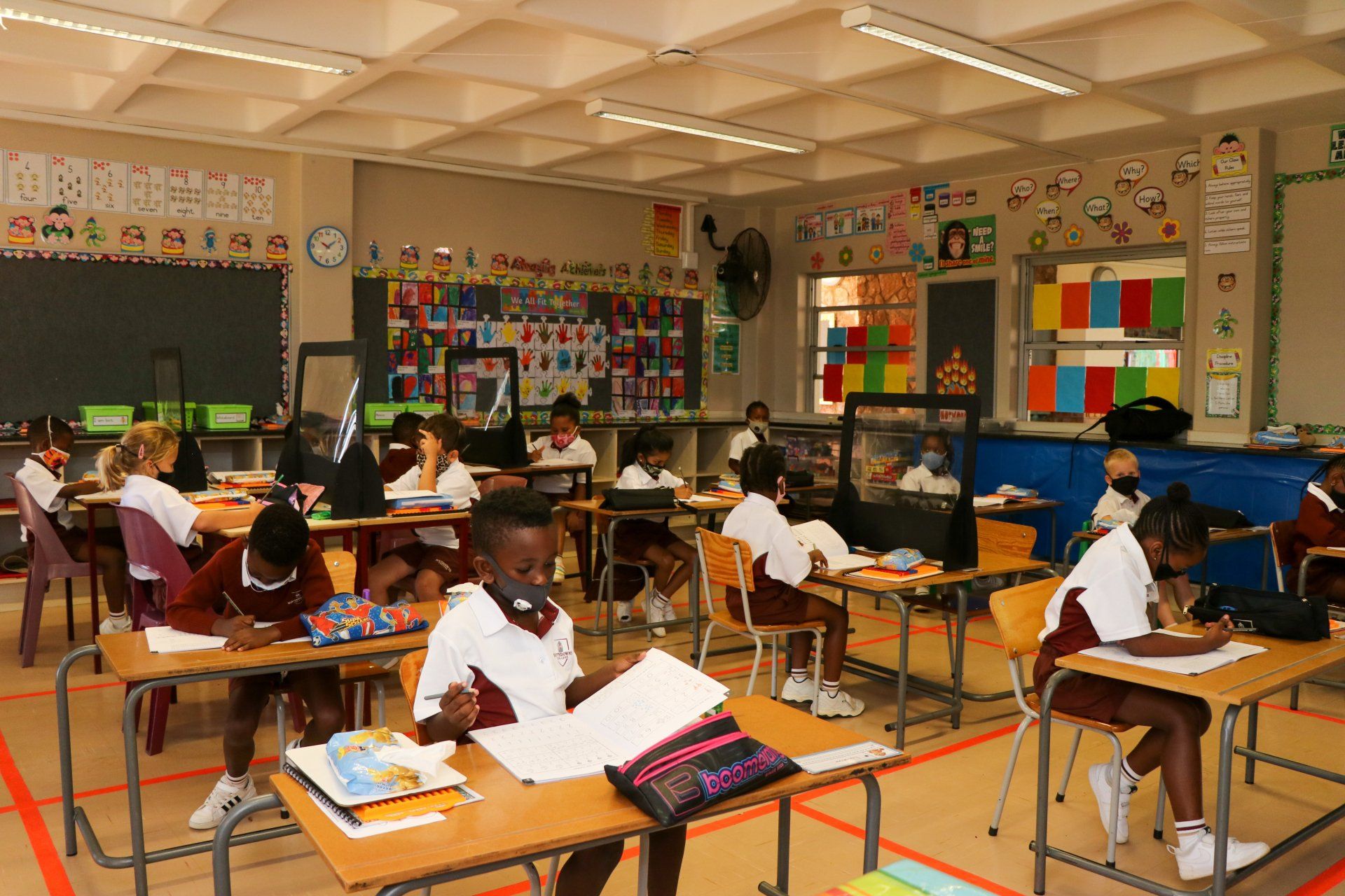 A group of children are sitting at their desks in a classroom.
