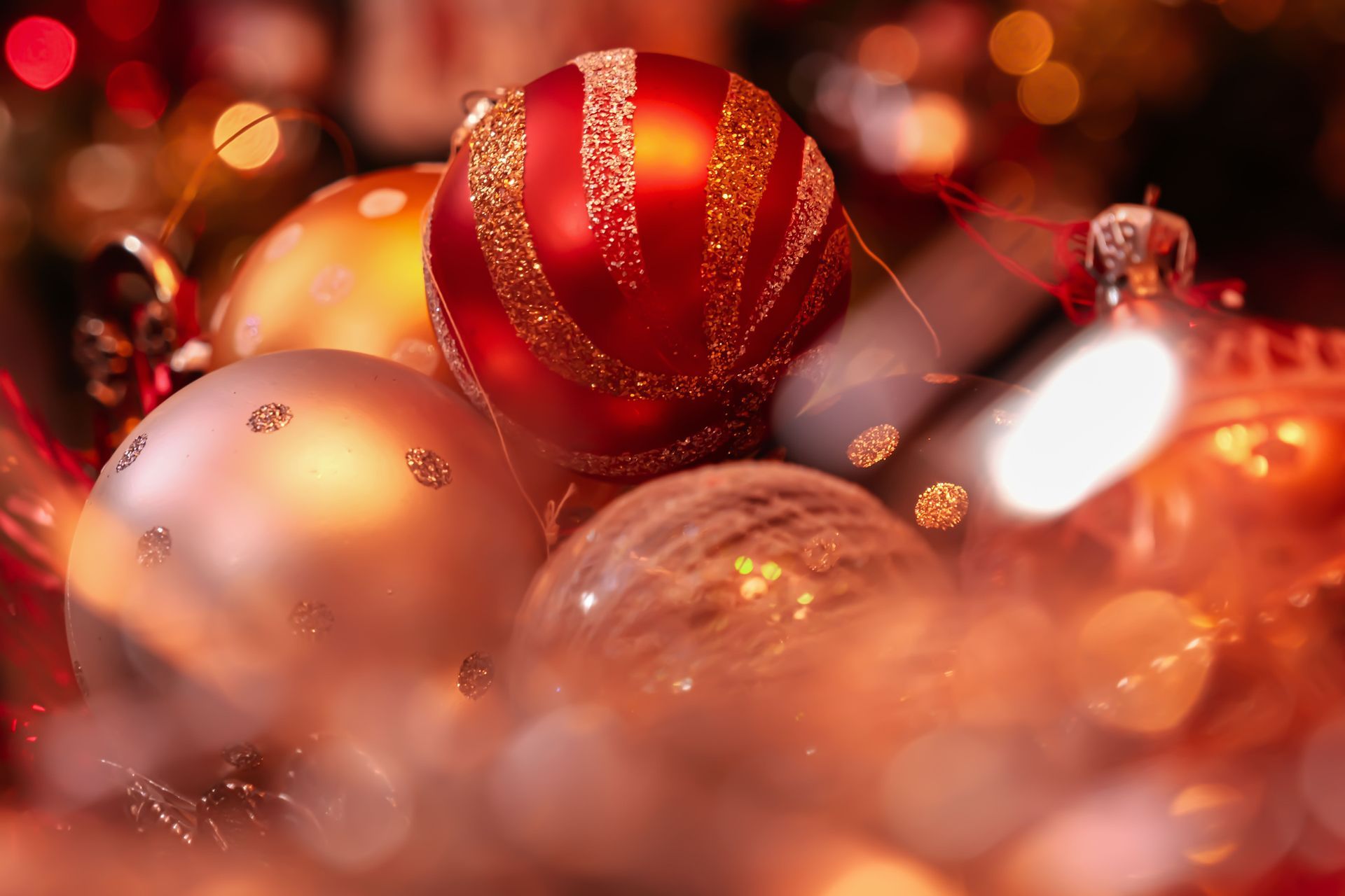 Red and gold Christmas ornaments with warm bokeh lights