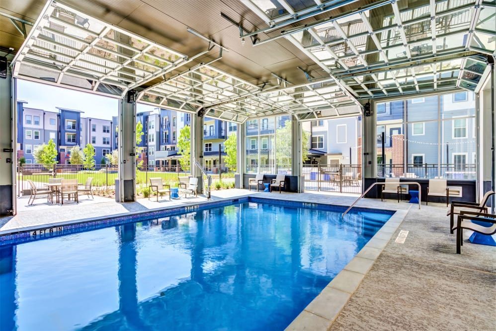 Indoor swimming pool with lounge seating in multifamily community