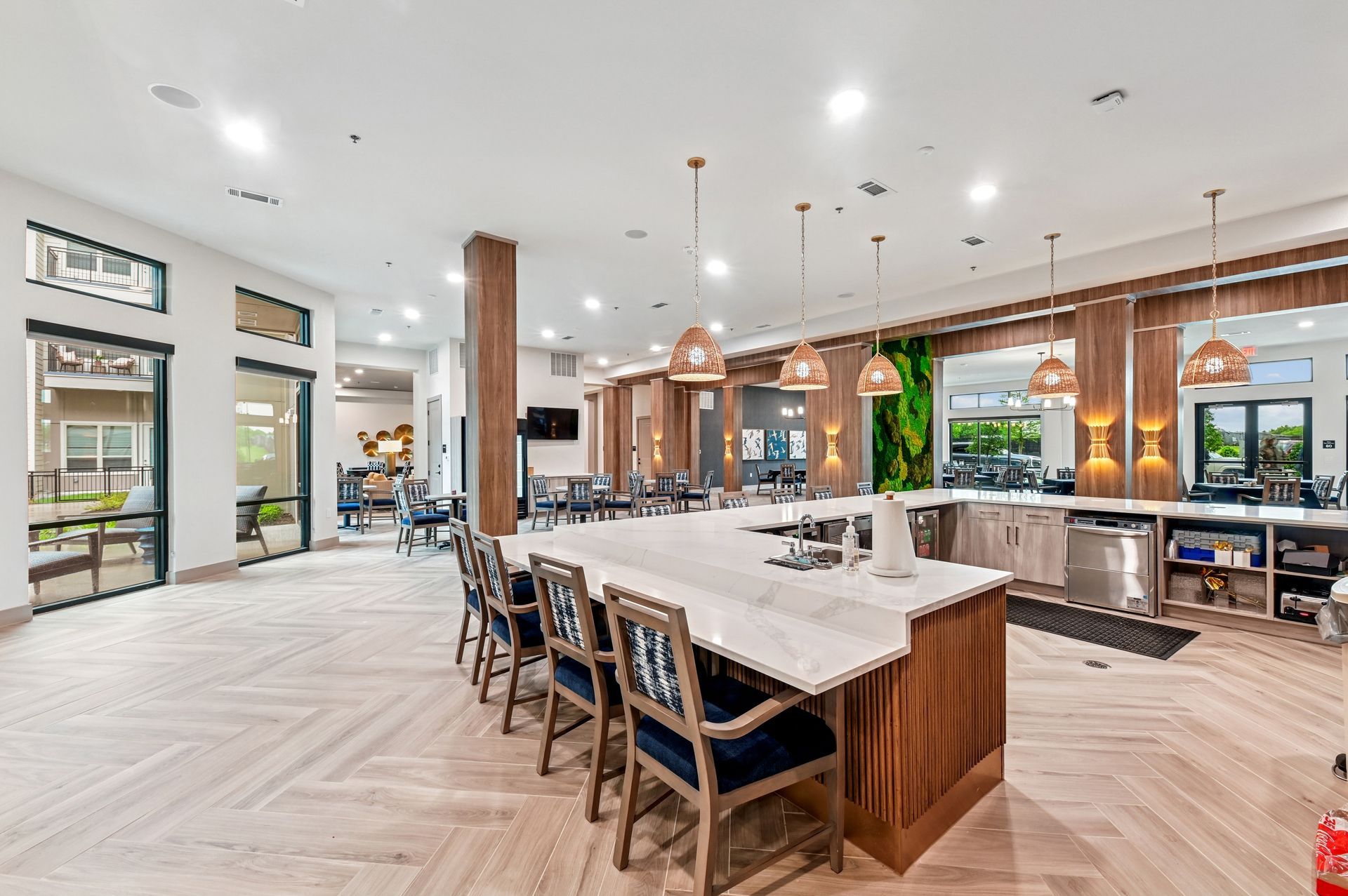 Spacious resident dining and gathering area with long table and contemporary design