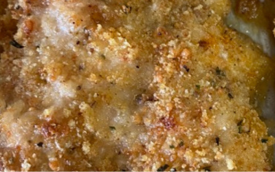 Close-up of a golden-brown baked crust with crumbly, textured surface