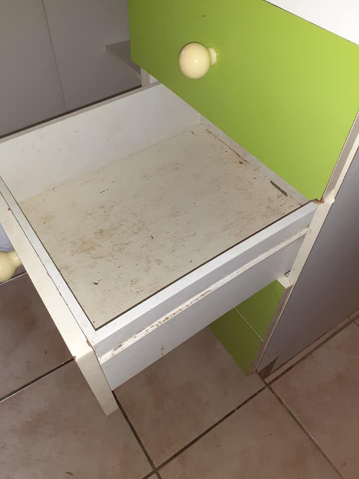 A Green And White Drawer With A White Handle Before Cleaning — McCarthys Property Services in Woolgoolga, NSW