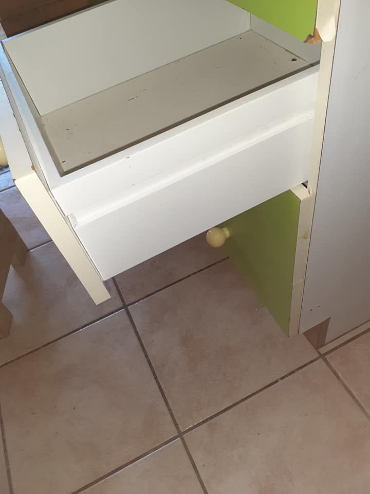 A White Drawer Is Open On A Tiled Floor After Cleaning — McCarthys Property Services in Woolgoolga, NSW