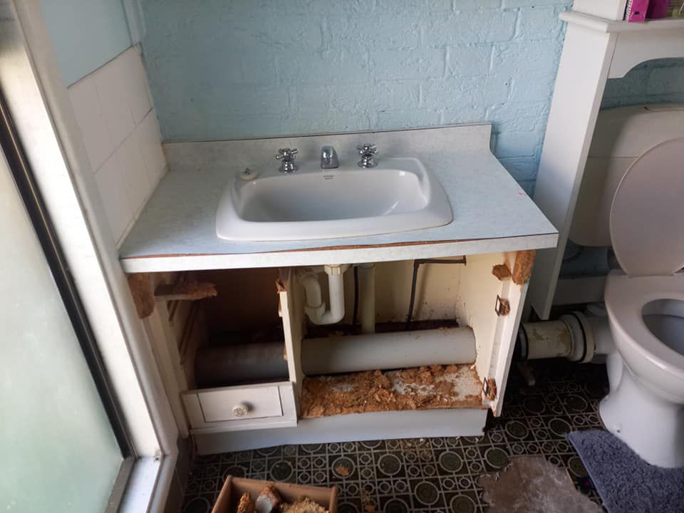 A Bathroom With A Sink And Toilet Before Sink Renovation — McCarthys Property Services in Maclean, NSW