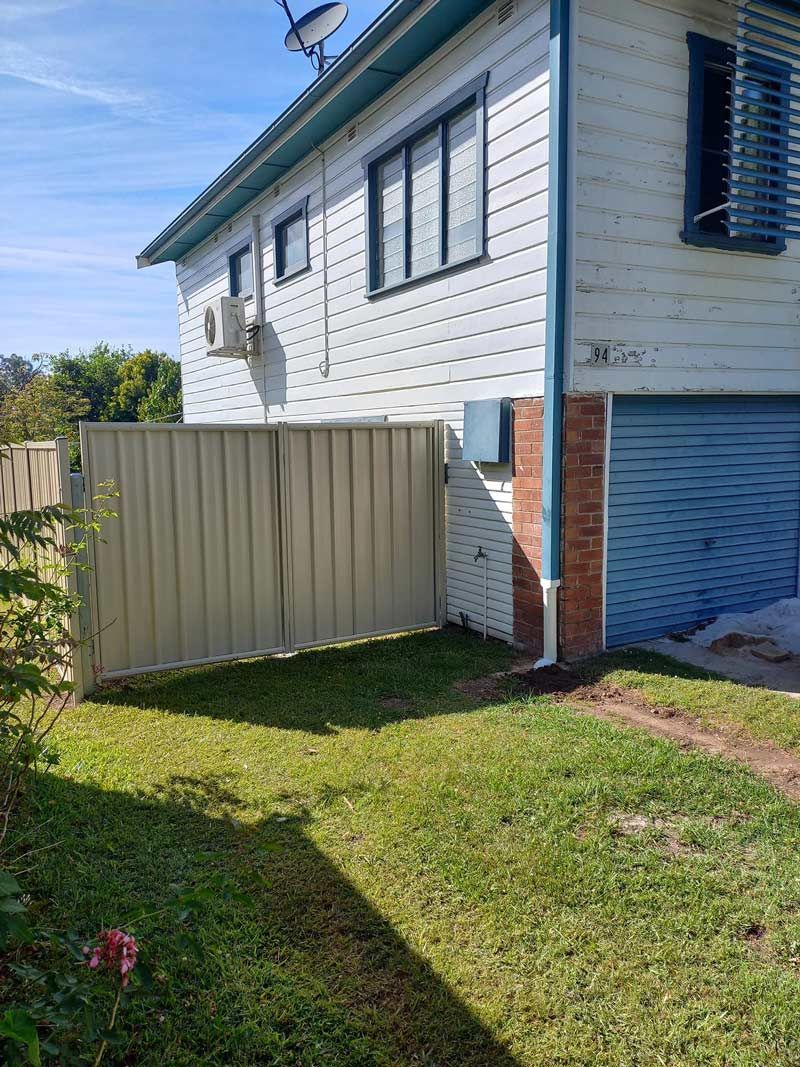A White House With A Fence In Front Of It — McCarthys Property Services in Maclean, NSW