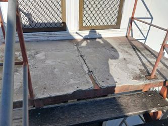 A Set Of Stairs Leading Up To A Building With A Metal Railing — McCarthys Property Services in Glenugie, NSW