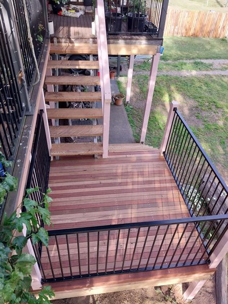 New Finish Wooden Deck With Stairs And A Metal Railing — McCarthys Property Services in Glenugie, NSW
