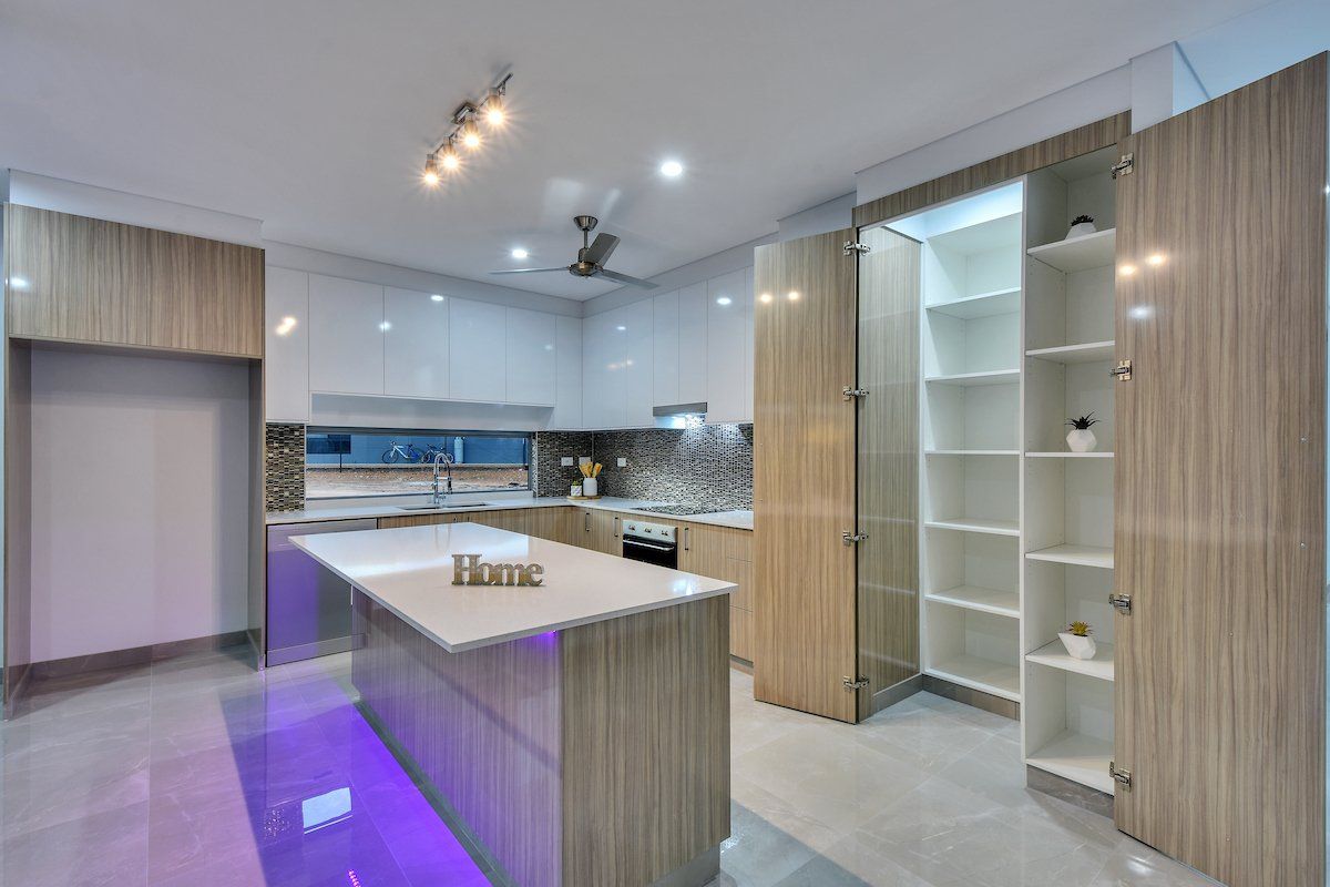 A kitchen with a large island and a pantry.