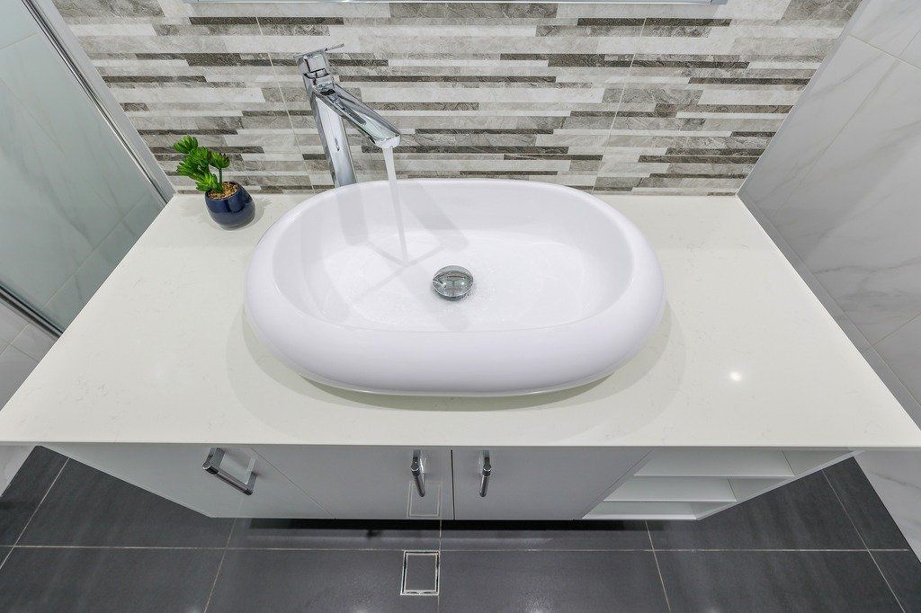 A bathroom sink with water running out of it.