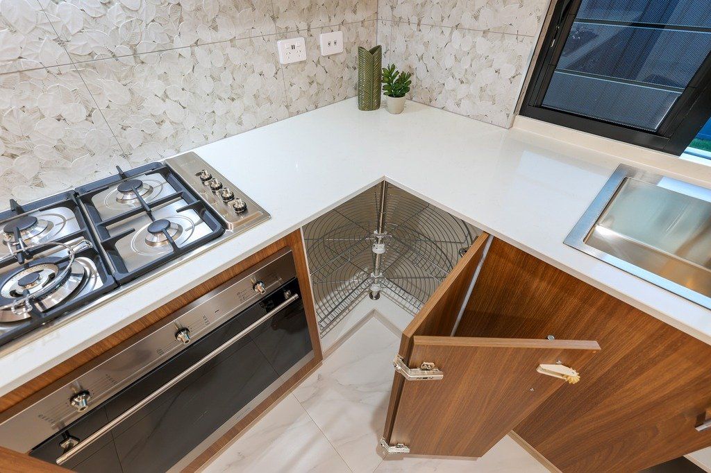A kitchen with a stove top oven and a sink