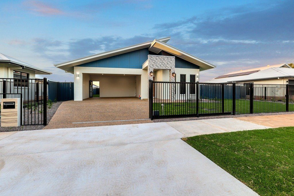 A house with a fence around it and a driveway