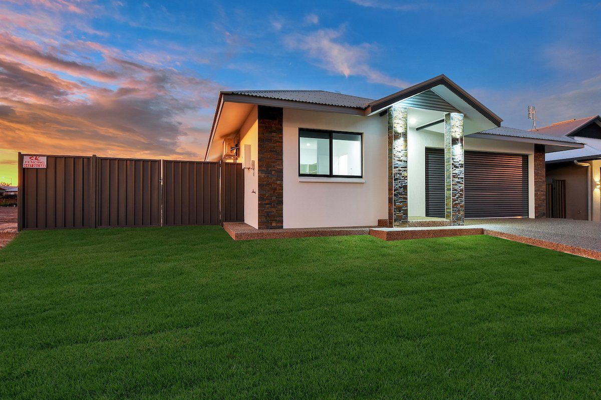 A small house with a large lawn in front of it.