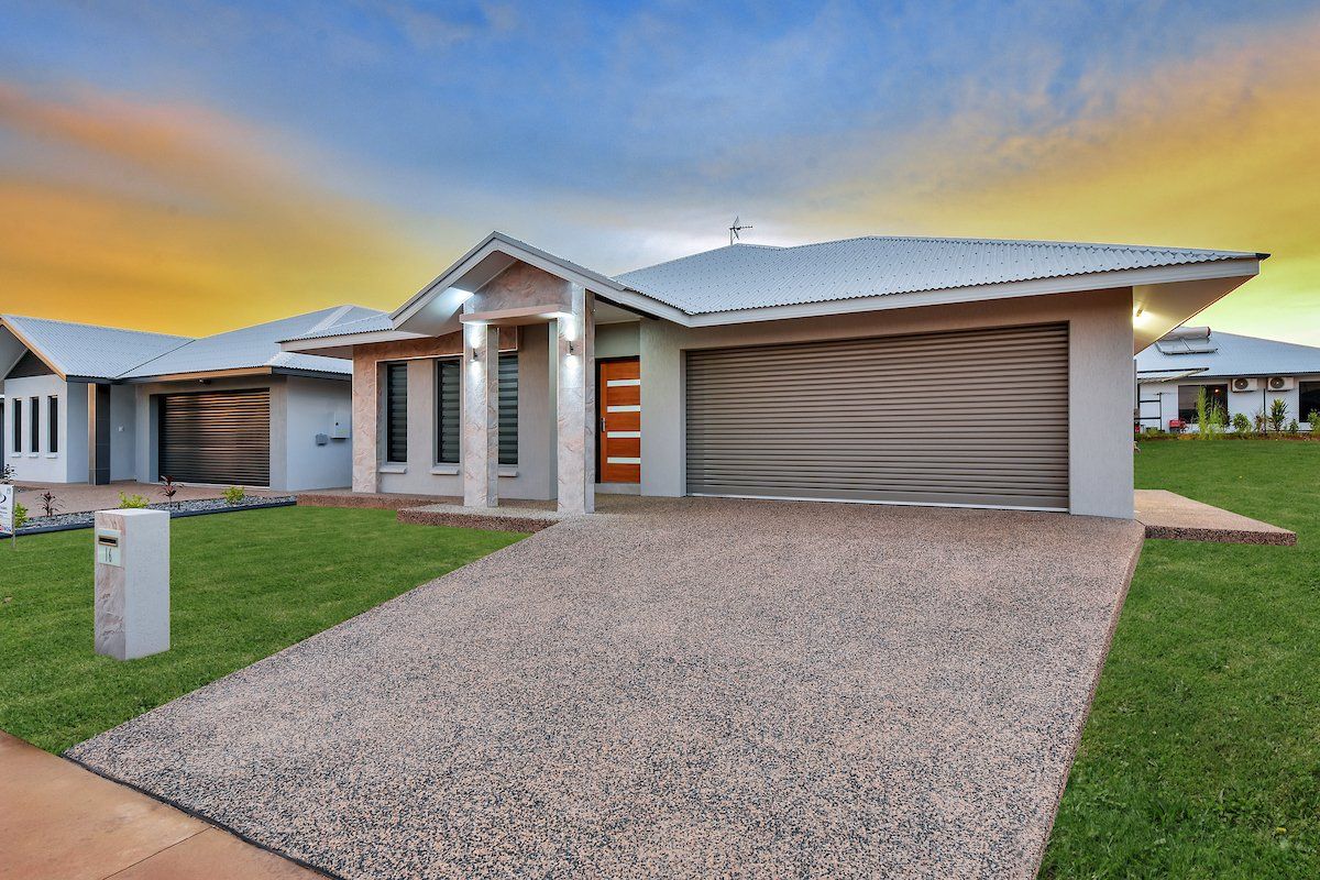 A large house with a garage and a driveway in front of it.