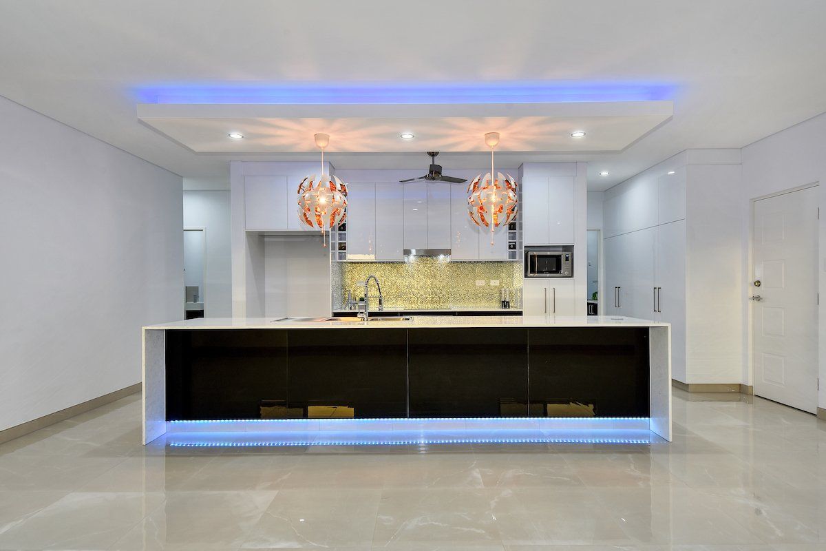 A kitchen with a large island in the middle of the room.