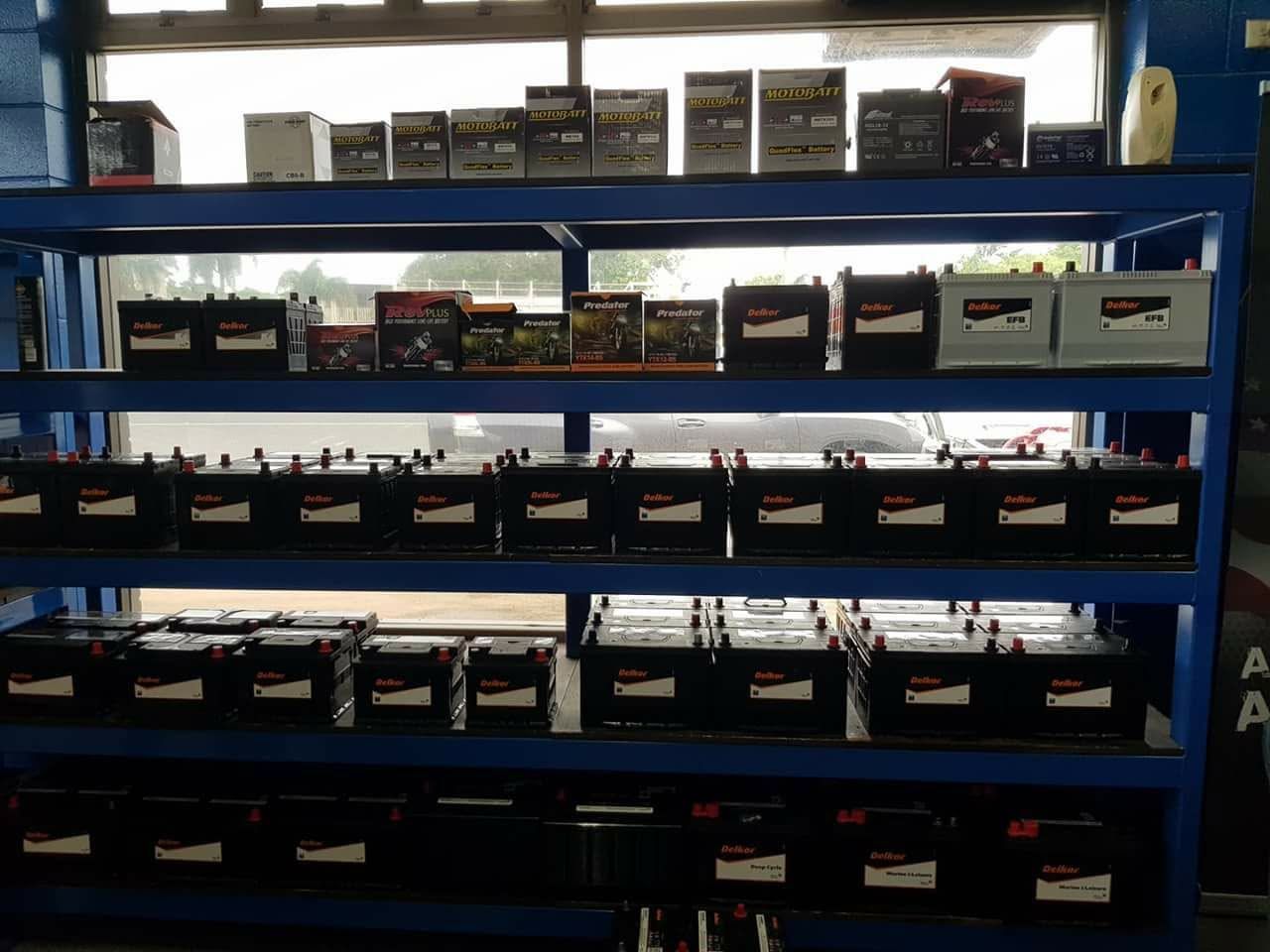 A Person Is Charging A Car Battery With A Pair Of Pliers — Goodyear Autocare Bowen in Bowen, QLD
