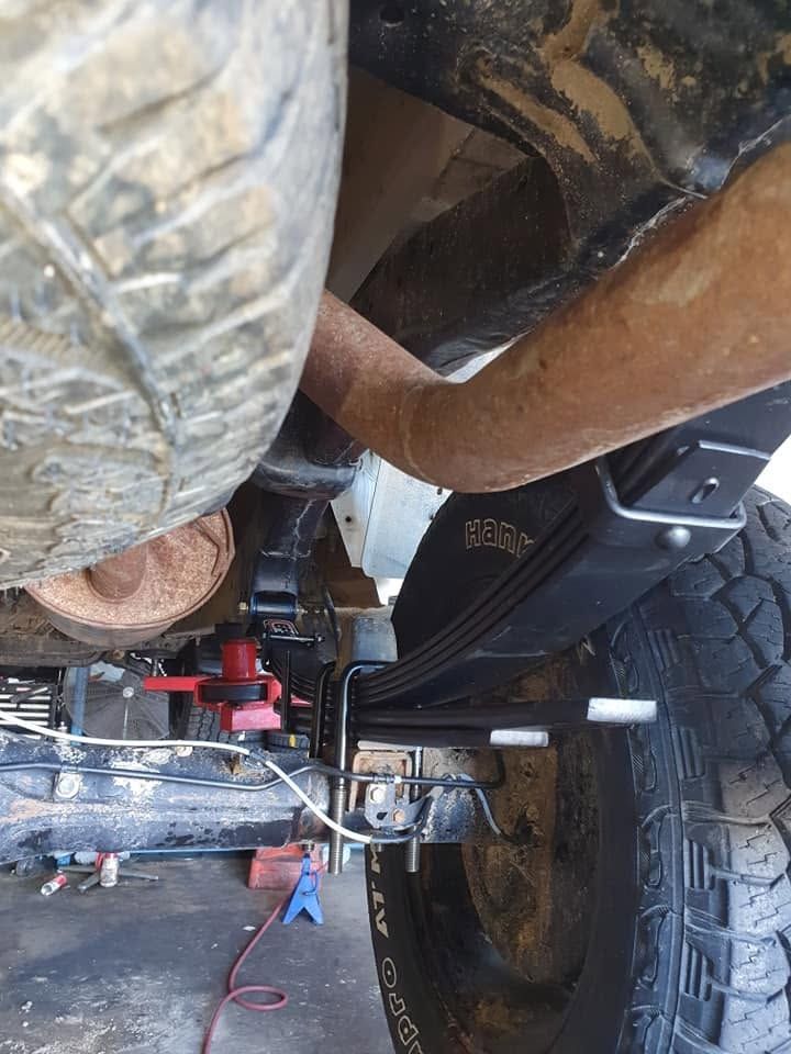 Undercarriage View of a Lifted Vehicle with Large Tires and Suspension Components — Goodyear Autocare Bowen in Bowen, QLD