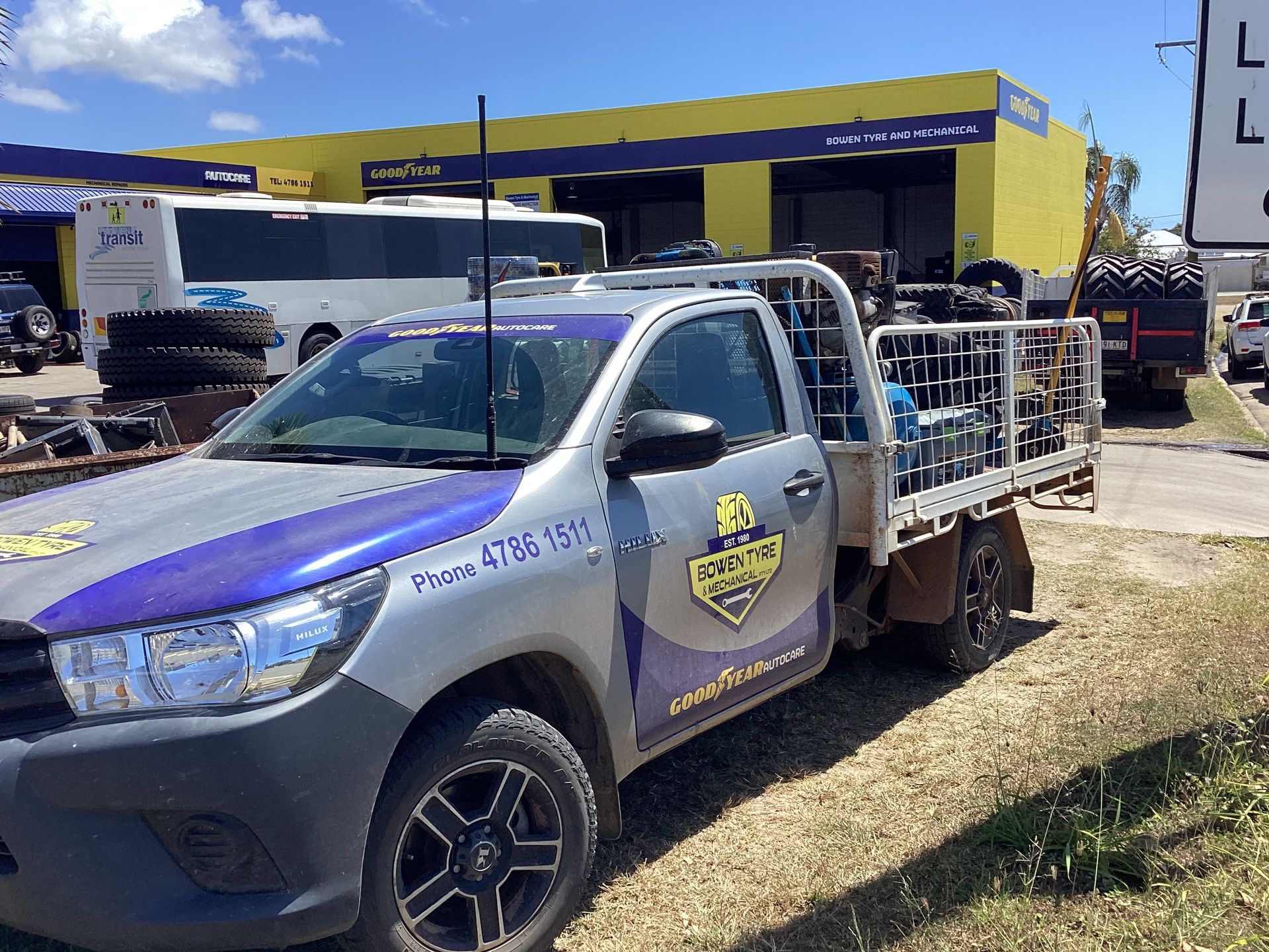 Two Men Are Working On A Broken Down Car On The Side Of The Road — Goodyear Autocare Bowen in Bowen, QLD