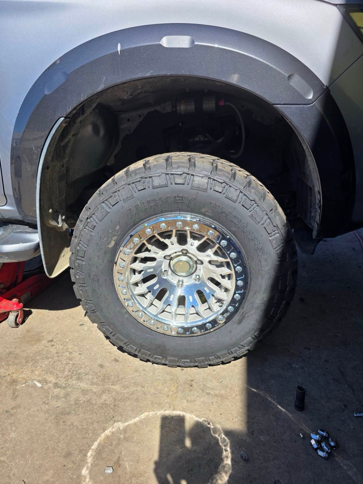 Gray SUV With Front Wheel Removed, Showing Chrome Rim and Tire — Goodyear Autocare Bowen in Bowen, QLD