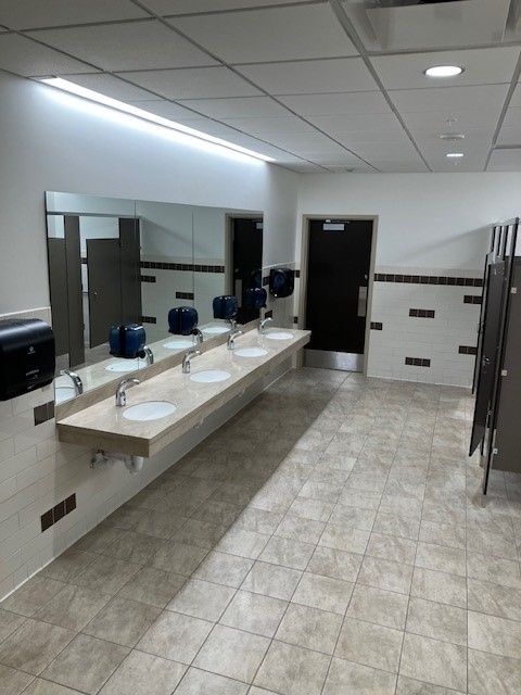 Woman Cleaning Office Table — Erie, PA — Peterson’s Property Maintenance