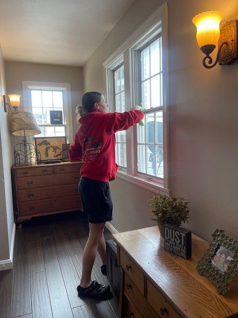 A woman is cleaning the railing of a staircase in a house. — Erie, PA — Peterson’s Property Maintenance
