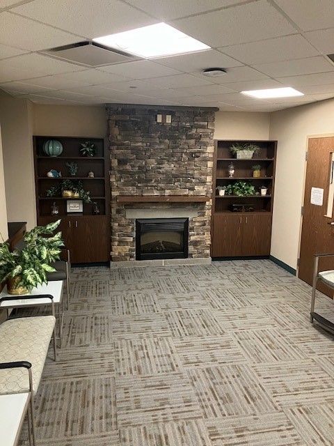 there is a fireplace in the middle of the room . | Erie, PA | Peterson's Property Maintenance