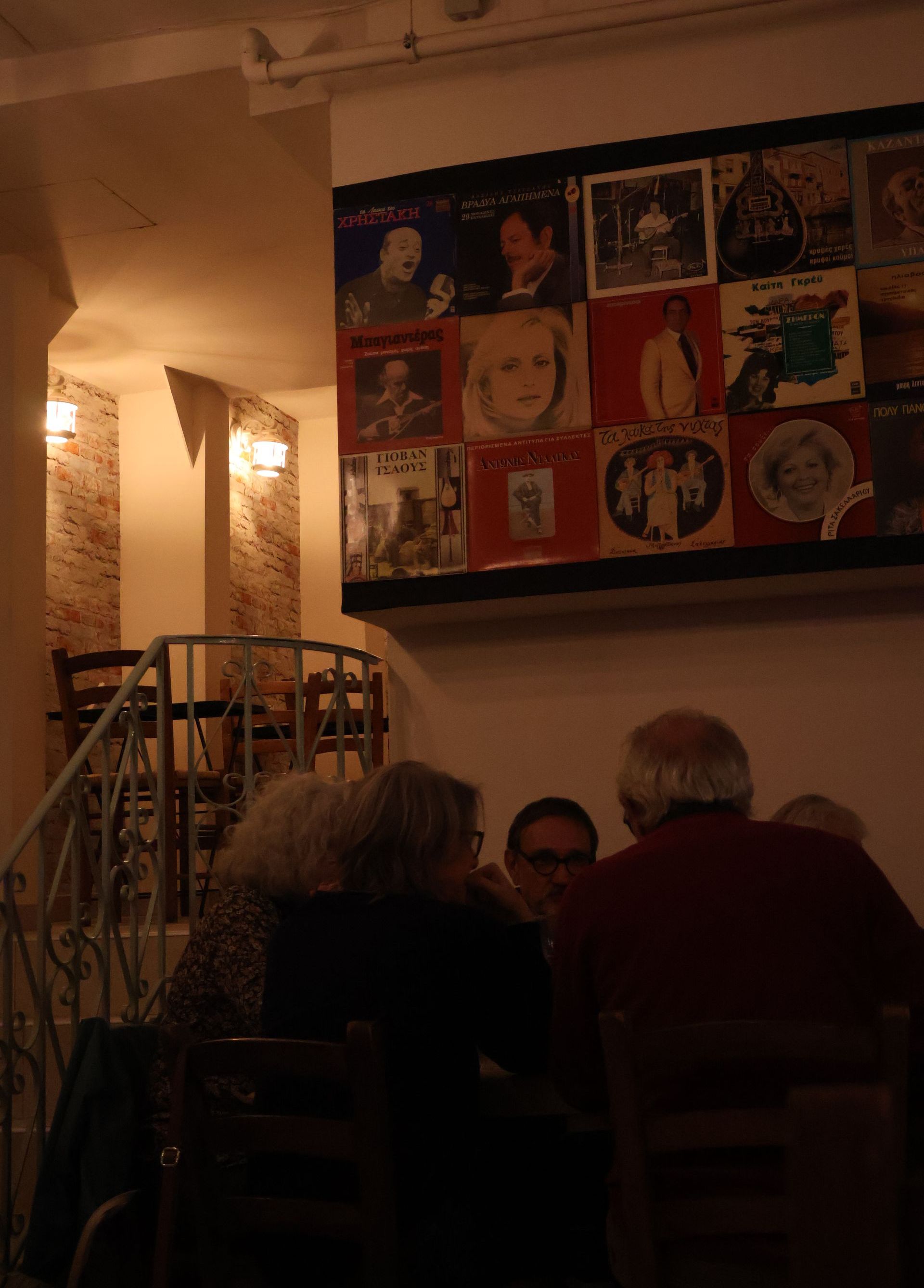 A restaurant with tables and chairs and a staircase
