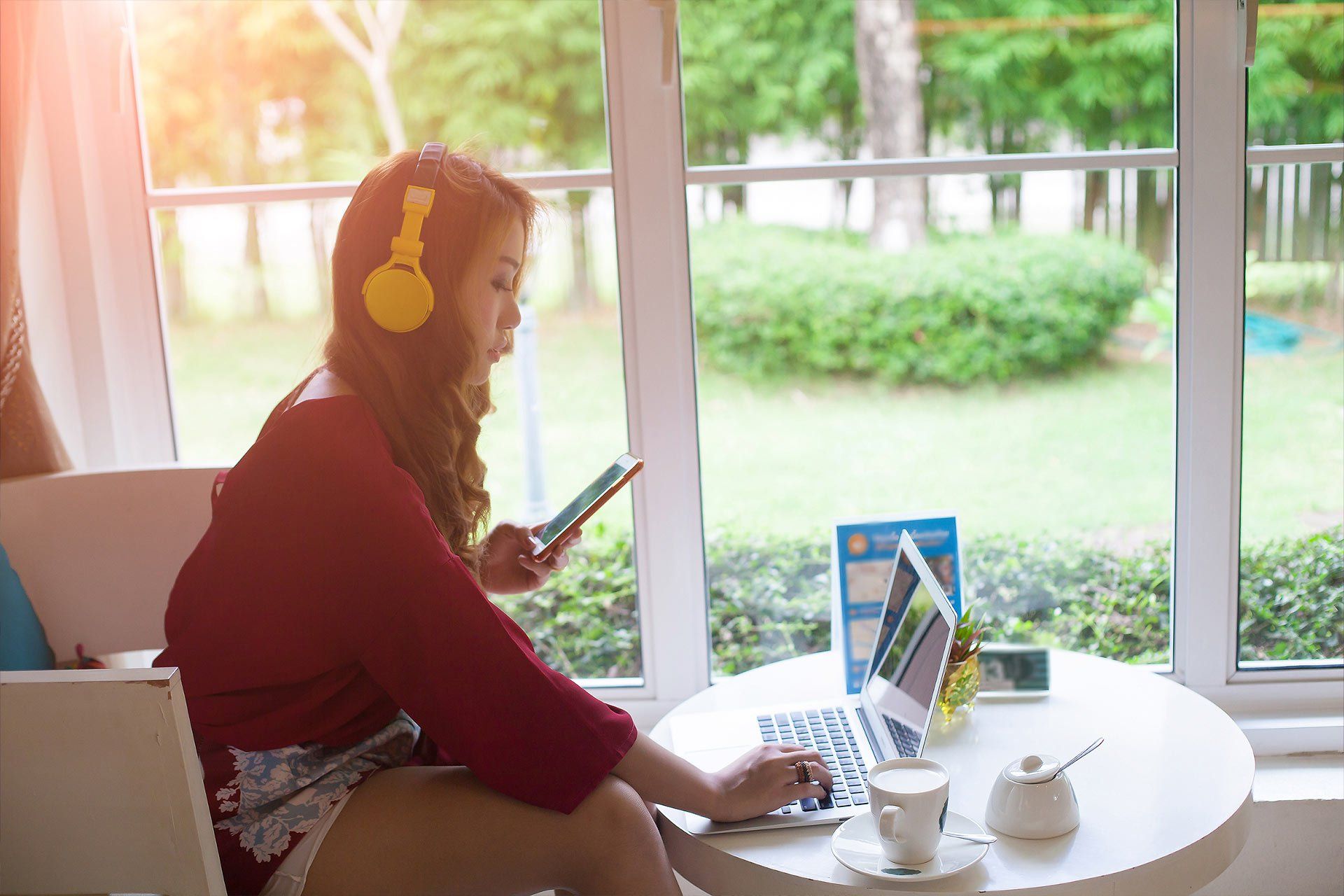 Young woman sat at table with laptop