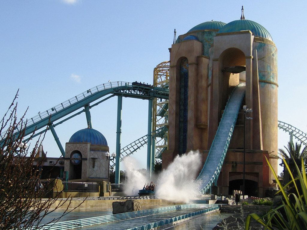 A roller coaster is going down a water slide at an amusement park