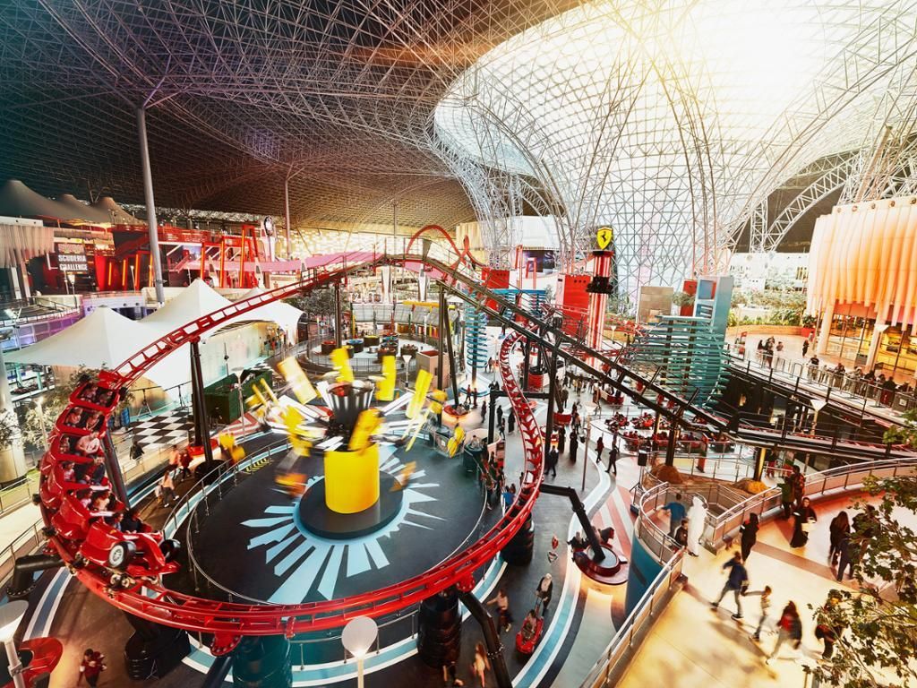 An aerial view of a roller coaster in an amusement park.