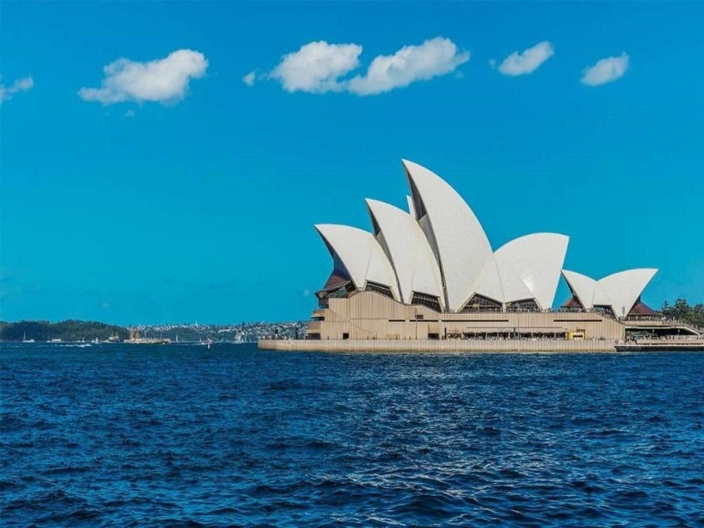 The sydney opera house is floating on top of a body of water.
