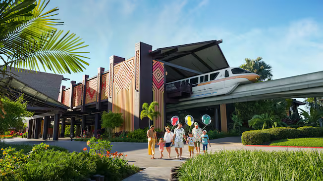 Family walking by a modern resort entrance with tropical landscaping and a bright blue sky
