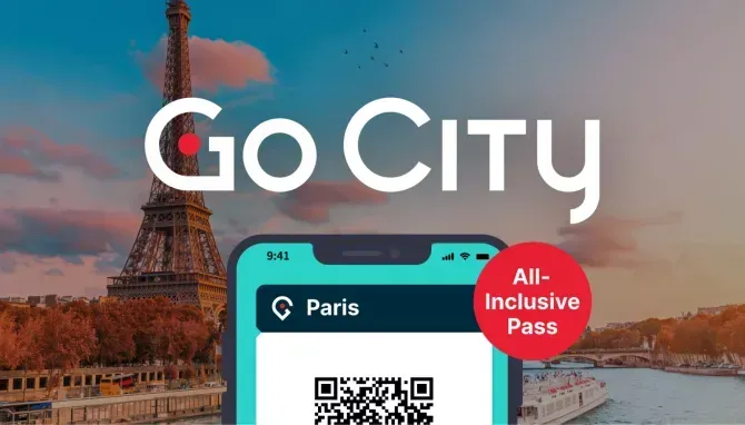 A phone with a qr code on it is displayed in front of the eiffel tower.